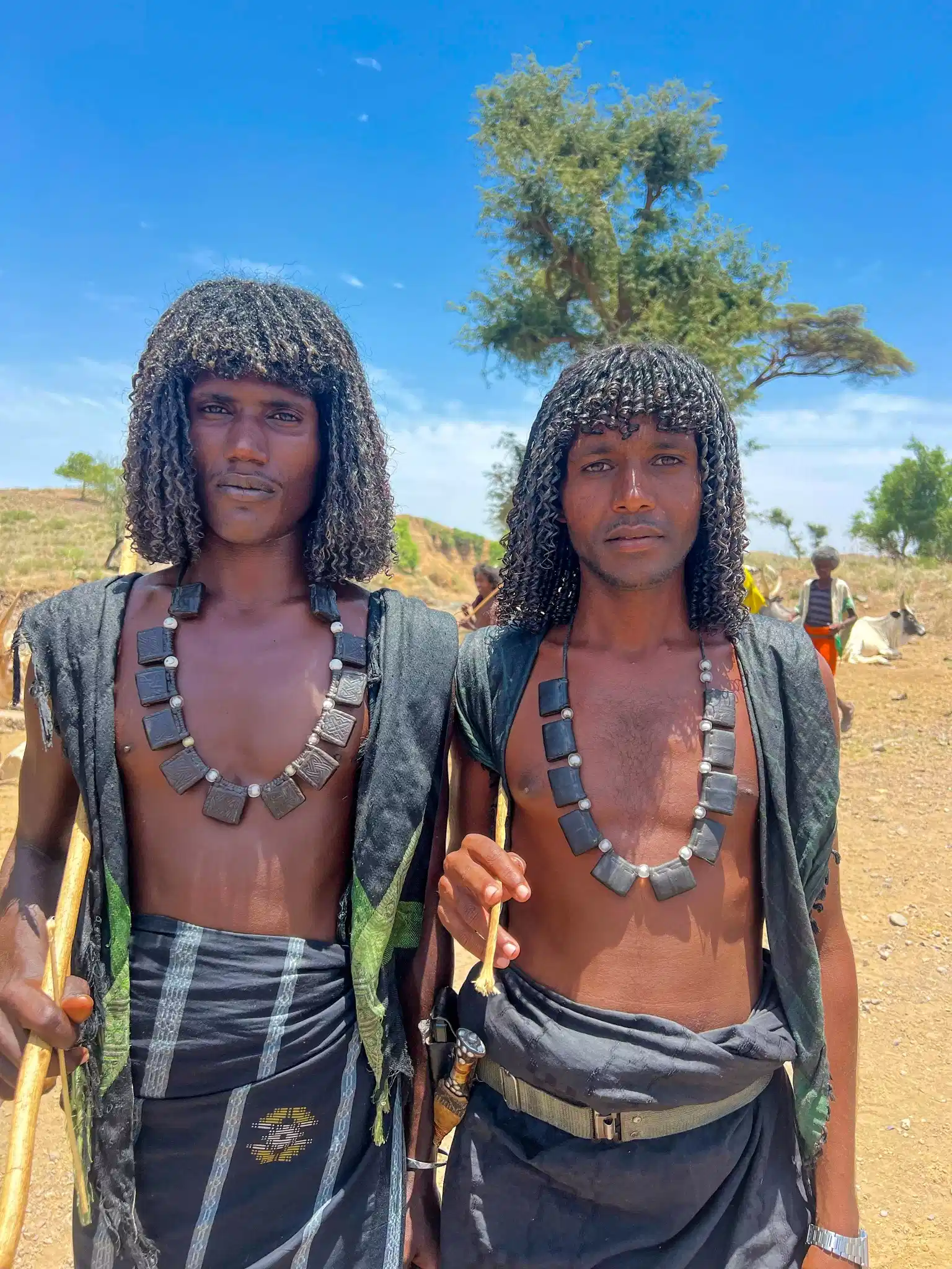 Two Afar men wearing traditional clothing and jewellery
