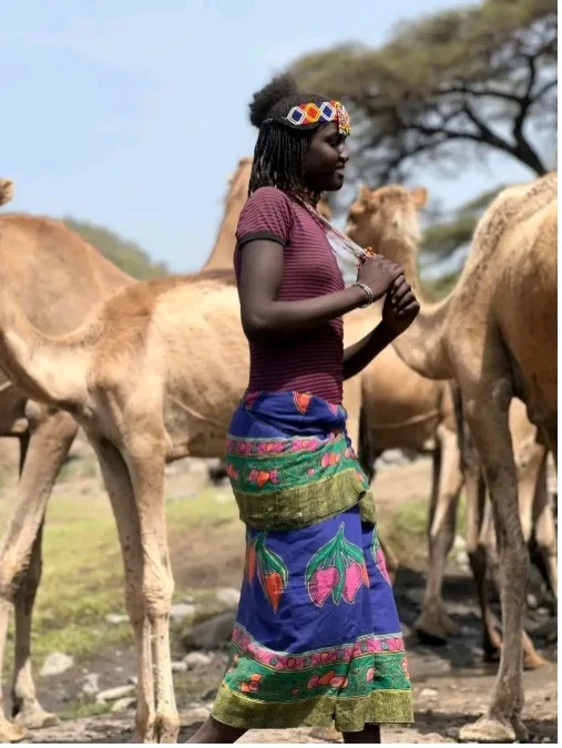 A community member beside livestock in the Samarobi and Galalu area